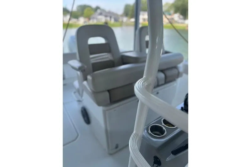 Slide: The Image of 2016 Boston Whaler 330 Outrage interior with cushioned seating and cup holders. - 30