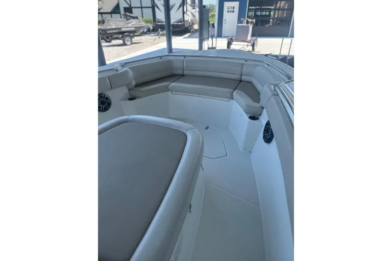 Slide: The Image of 2016 Boston Whaler 330 Outrage boat interior with cushioned seating and speakers. - 32