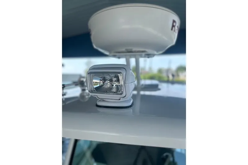 Slide: The Image of Close-up of a 2016 Boston Whaler 330 Outrage boat's radar and spotlight. - 35