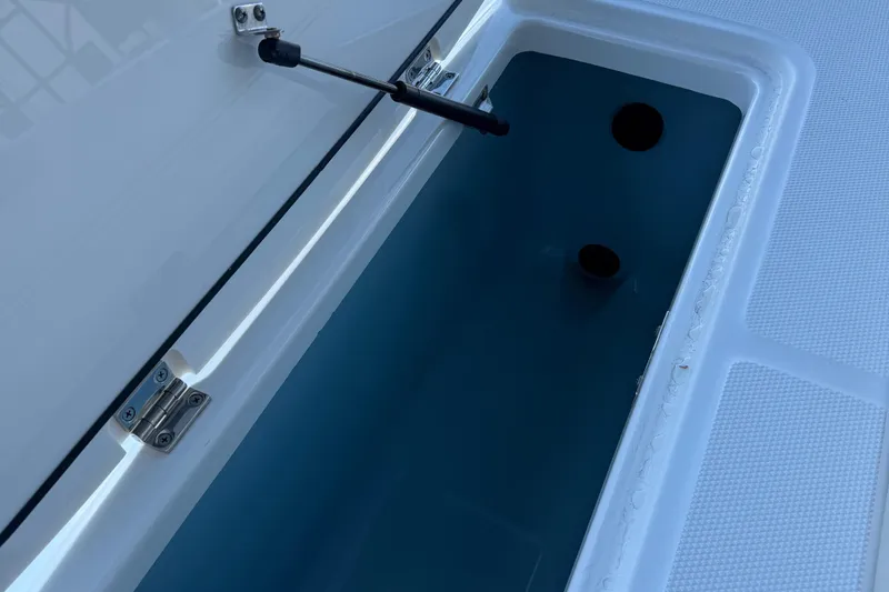 Slide: The Image of Open storage compartment on a 2016 Boston Whaler 330 Outrage boat. - 39