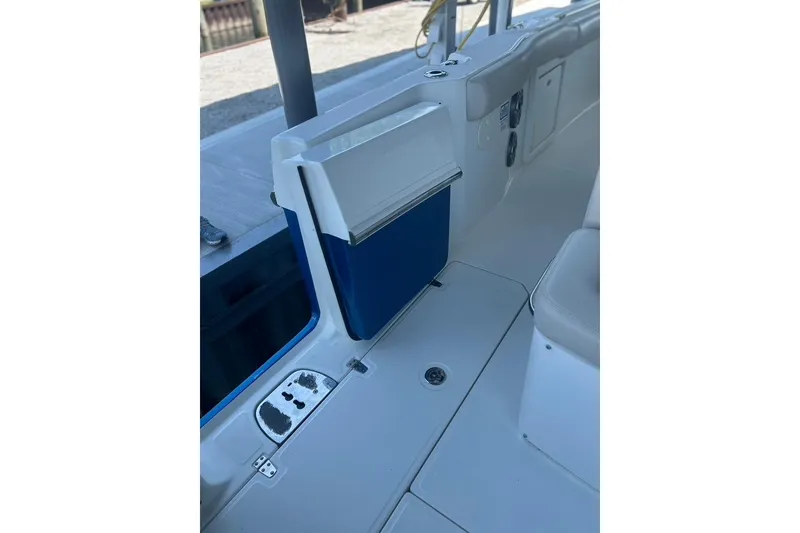 Slide: The Image of 2016 Boston Whaler 330 Outrage interior, featuring seating and storage compartments. - 40