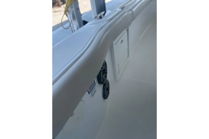 Slide: The Image of 2016 Boston Whaler 330 Outrage interior detail with speakers and storage compartment. - 41