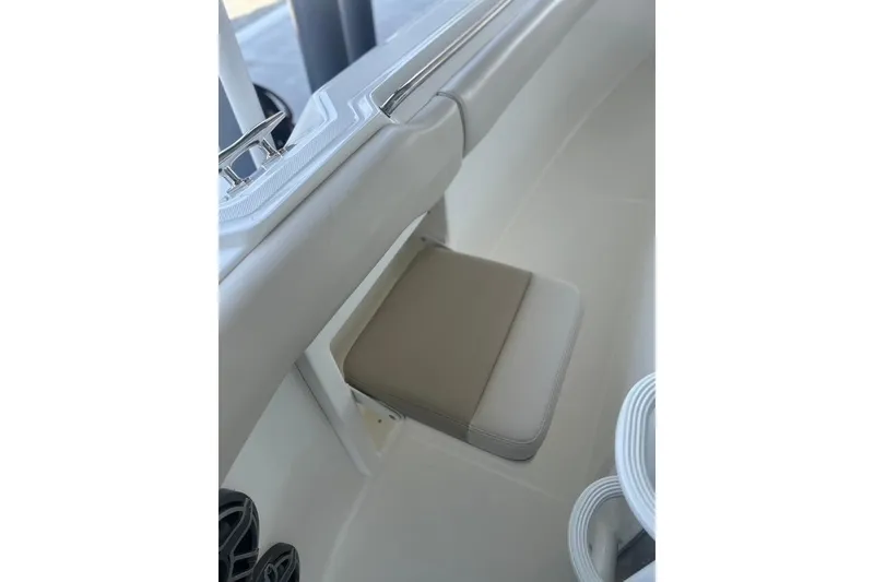 Slide: The Image of 2016 Boston Whaler 330 Outrage boat seat detail with beige cushion. - 42