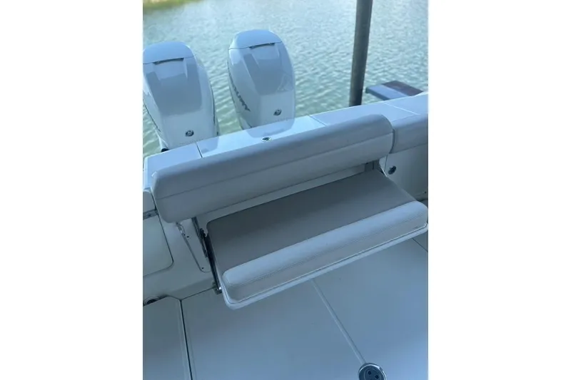 Slide: The Image of 2016 Boston Whaler 330 Outrage boat seat and dual engines on water. - 46