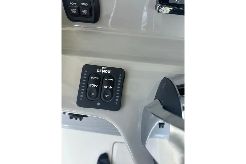 Slide: The Image of Control panel of a 2016 Boston Whaler 330 Outrage boat with Lenco trim tab switches. - 48
