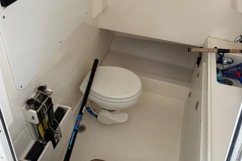 Slide: The Image of Interior of 2016 Boston Whaler 330 Outrage boat with toilet and storage area. - 9