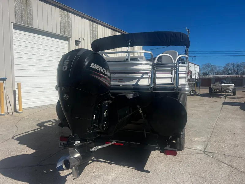 Slide: The Image of 2019 Ranger Reata 223F boat with Mercury outboard motor, parked outdoors. - 10
