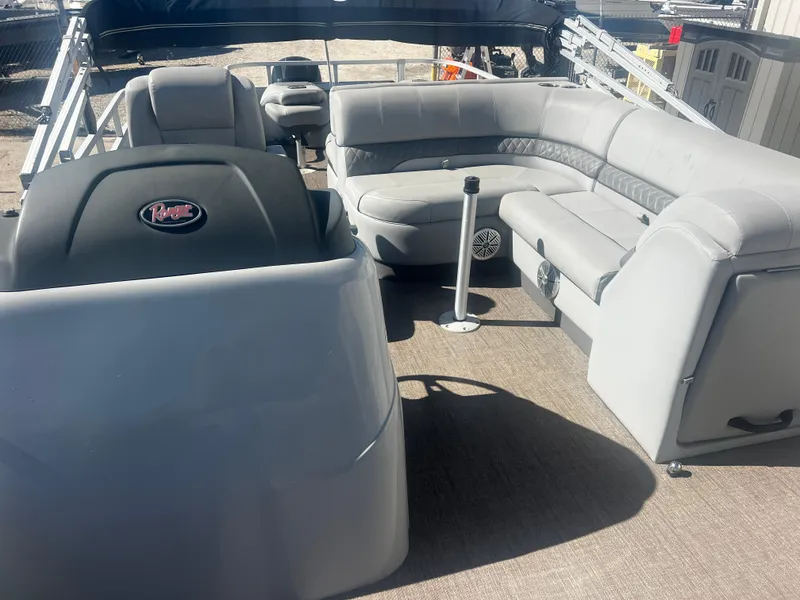 Slide: The Image of 2019 Ranger Reata 223F boat interior with gray seating and steering console. - 3