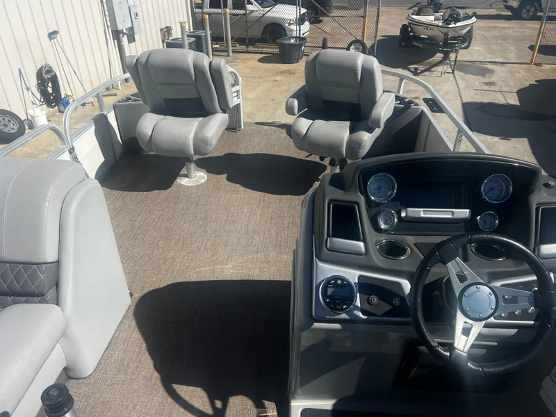 Slide: The Image of 2019 Ranger Reata 223F boat interior with steering console and cushioned seating. - 4