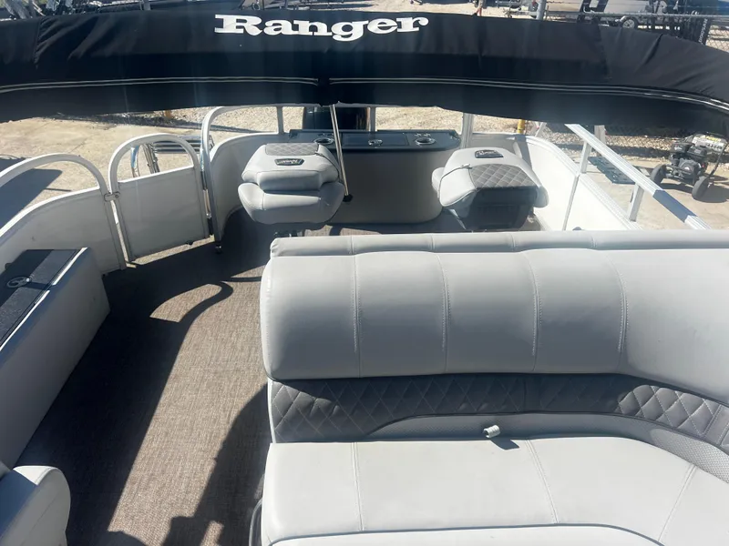 Slide: The Image of 2019 Ranger Reata 223F boat interior with gray seating and canopy. - 5