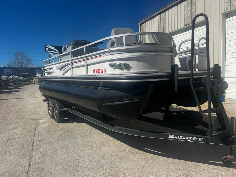 Slide: The Image of 2019 Ranger Reata 223F pontoon boat on trailer, parked outdoors. - 7