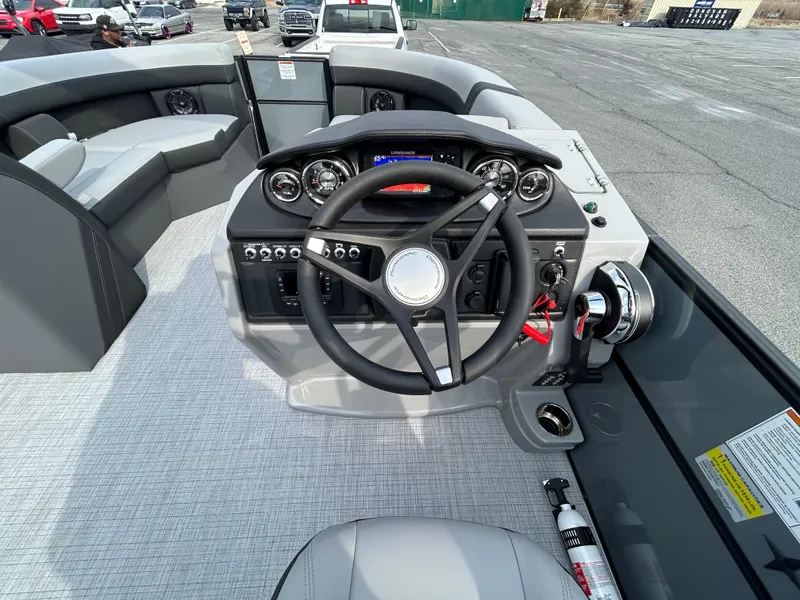 Slide: The Image of 2025 Berkshire 22RFX ARCH CTS 2.75 boat dashboard with steering wheel and controls. - 13