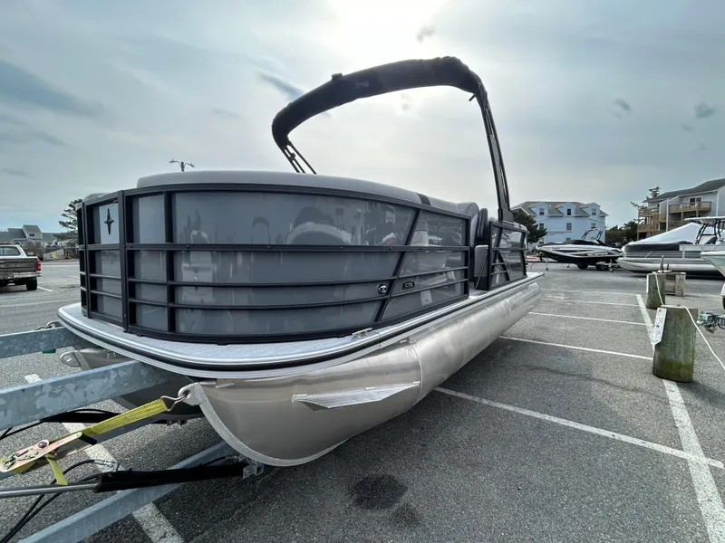 Slide: The Image of 2025 Berkshire 22RFX ARCH CTS 2.75 pontoon boat in a parking lot. - 2
