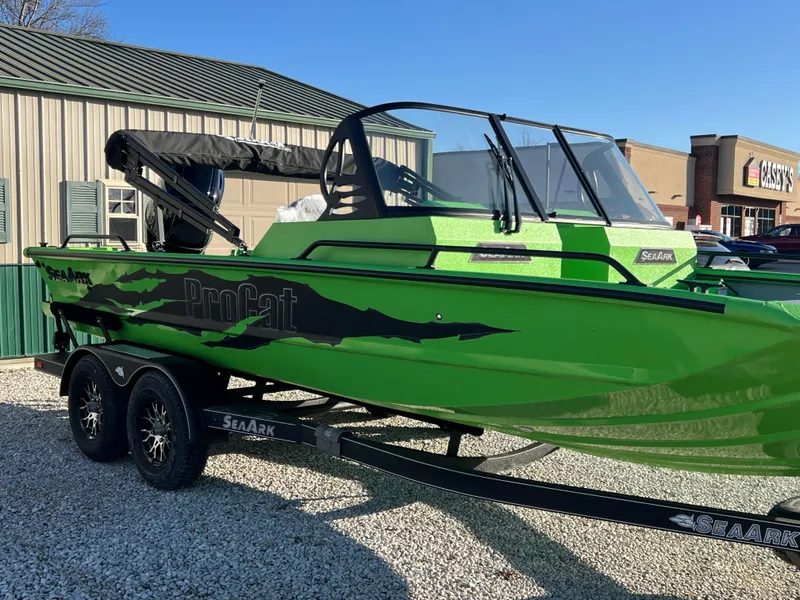 The Image of 2025 SeaArk ProCat 200 boat in green, displayed indoors on a trailer. - 0
