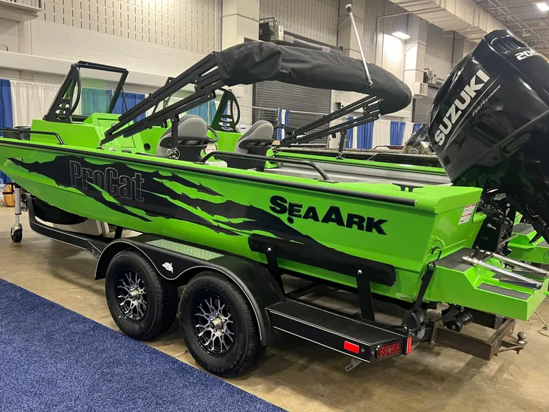 Slide: The Image of 2025 SeaArk ProCat 200 boat interior illuminated with vibrant green lighting. - 1