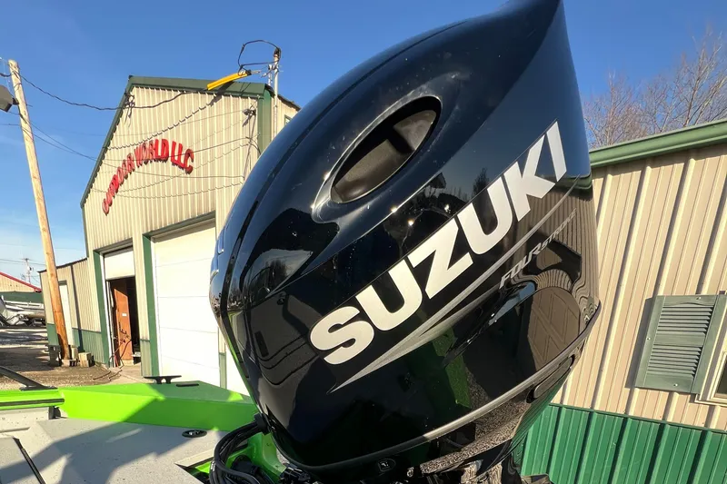 Slide: The Image of 2025 SeaArk ProCat 200 with Suzuki outboard motor, parked near a building. - 10