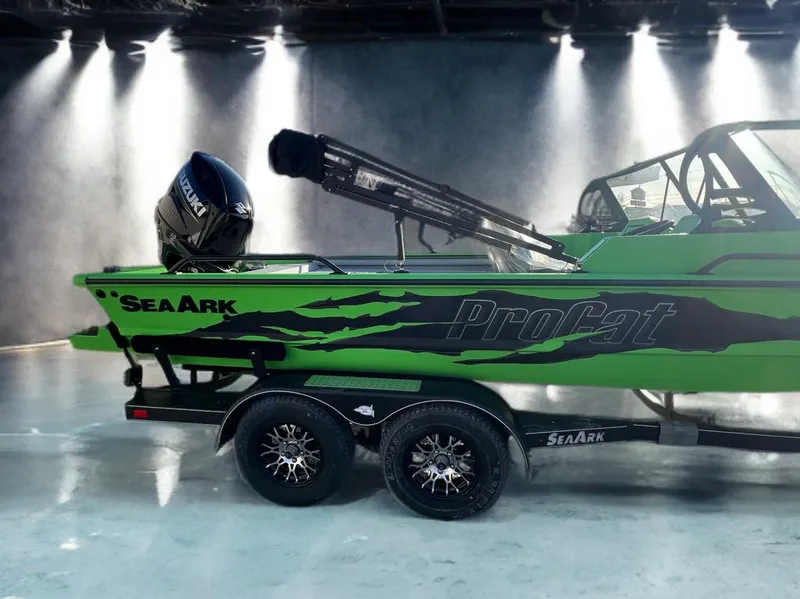 Slide: The Image of 2025 SeaArk ProCat 200 boat in vibrant green with Suzuki engine, displayed indoors. - 3