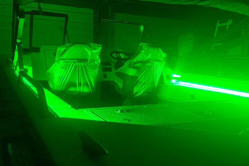 Slide: The Image of 2025 SeaArk ProCat 200 boat interior with vibrant green LED lighting. - 6