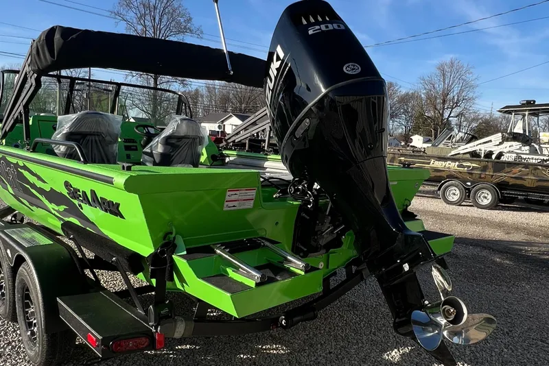 Slide: The Image of 2025 SeaArk ProCat 200 boat with green exterior and powerful outboard motor. - 8