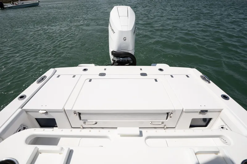 Slide: The Image of 2025 Blackfin 262 HB boat stern view with outboard motor on water. - 6