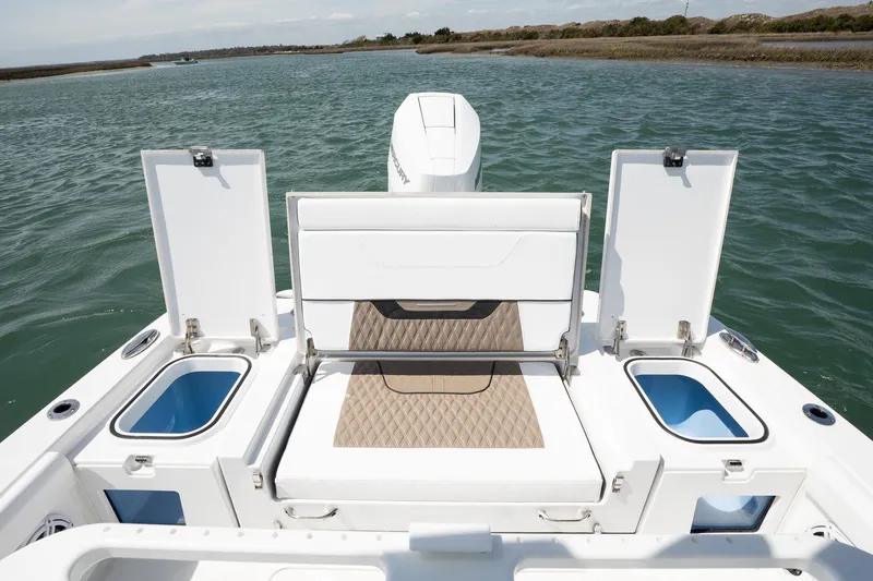 Slide: The Image of 2025 Blackfin 262 HB boat with open storage compartments on calm water. - 7