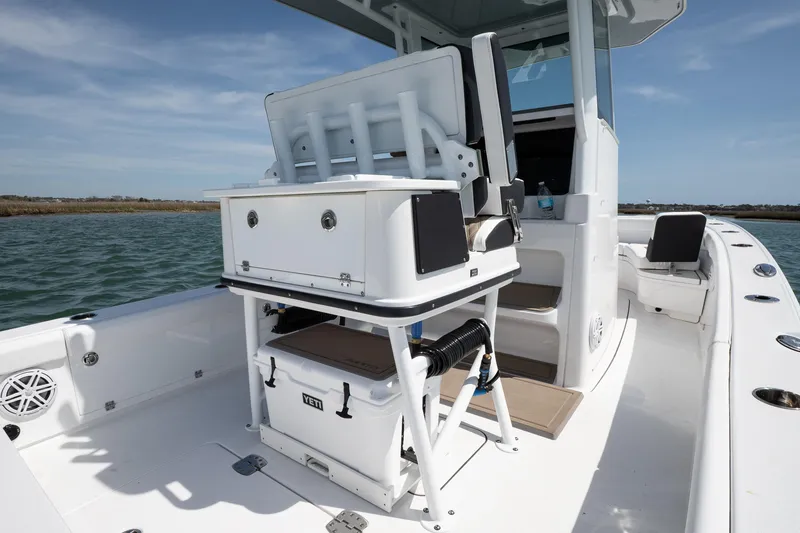 Slide: The Image of 2025 Blackfin 262 HB boat interior with seating and storage on calm water. - 8