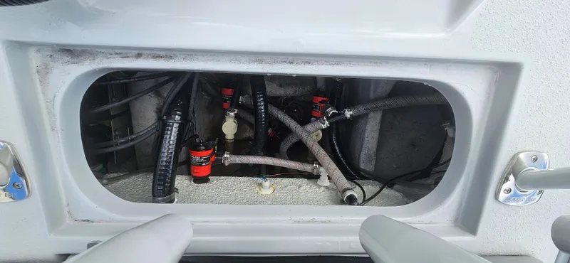 Slide: The Image of 2023 Blazer Bay 2420 GTS boat compartment with visible hoses and fittings. - 9