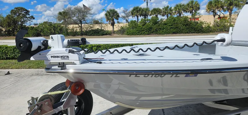 Slide: The Image of 2023 Blazer Bay 2420 GTS boat with Minn Kota trolling motor, parked outdoors. - 5