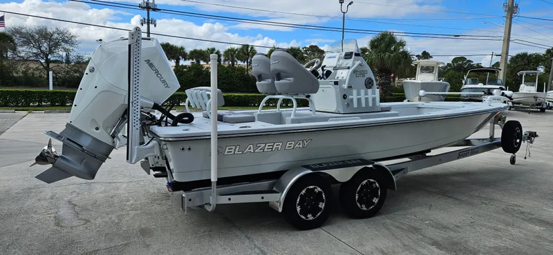 The Image of 2023 Blazer Bay 2420 GTS boat on trailer, featuring sleek design and powerful outboard motor. - 1