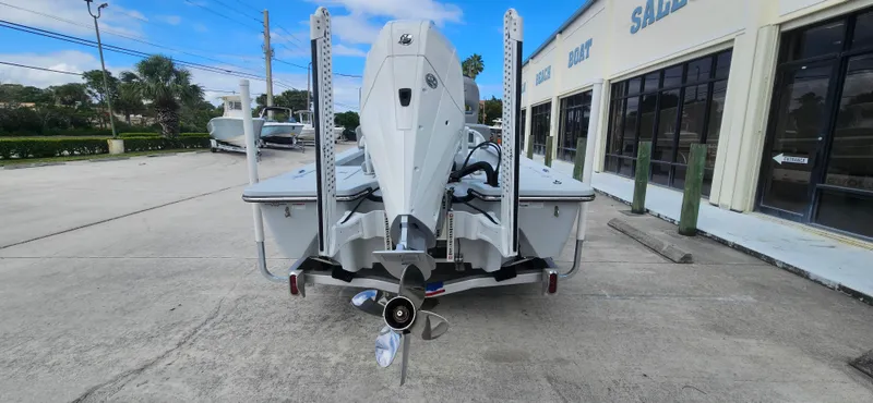 Slide: The Image of 2023 Blazer Bay 2420 GTS boat rear view in dealership lot. - 2