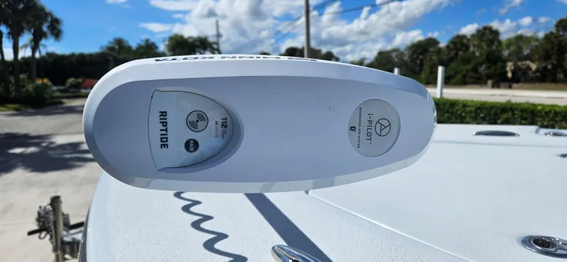 Slide: The Image of 2023 Blazer Bay 2420 GTS boat with Riptide trolling motor, outdoors under blue sky. - 6