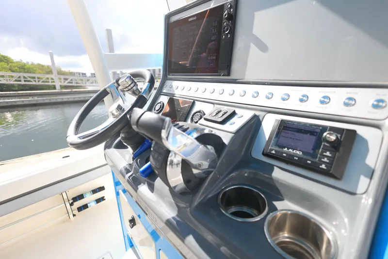 Slide: The Image of Helm of 2021 ShearWater 27 Carolina boat with modern controls and navigation system. - 11