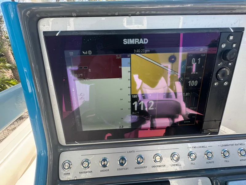 Slide: The Image of Simrad navigation display on 2021 ShearWater 27 Carolina boat dashboard. - 13