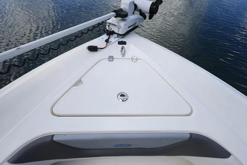 Slide: The Image of 2021 ShearWater 27 Carolina boat bow with trolling motor on calm water. - 20