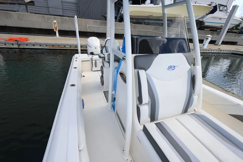Slide: The Image of 2021 ShearWater 27 Carolina boat docked, showcasing sleek seating and modern design. - 24