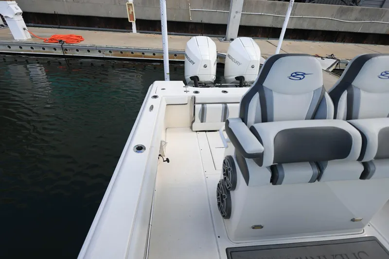Slide: The Image of 2021 ShearWater 27 Carolina boat with dual engines docked at marina. - 34