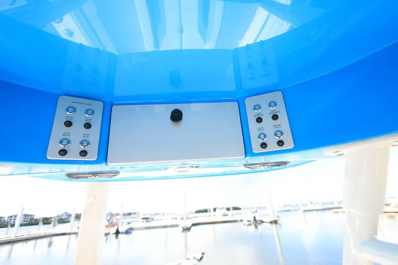 Slide: The Image of Control panel of 2021 ShearWater 27 Carolina boat, featuring blue accents and marina view. - 35
