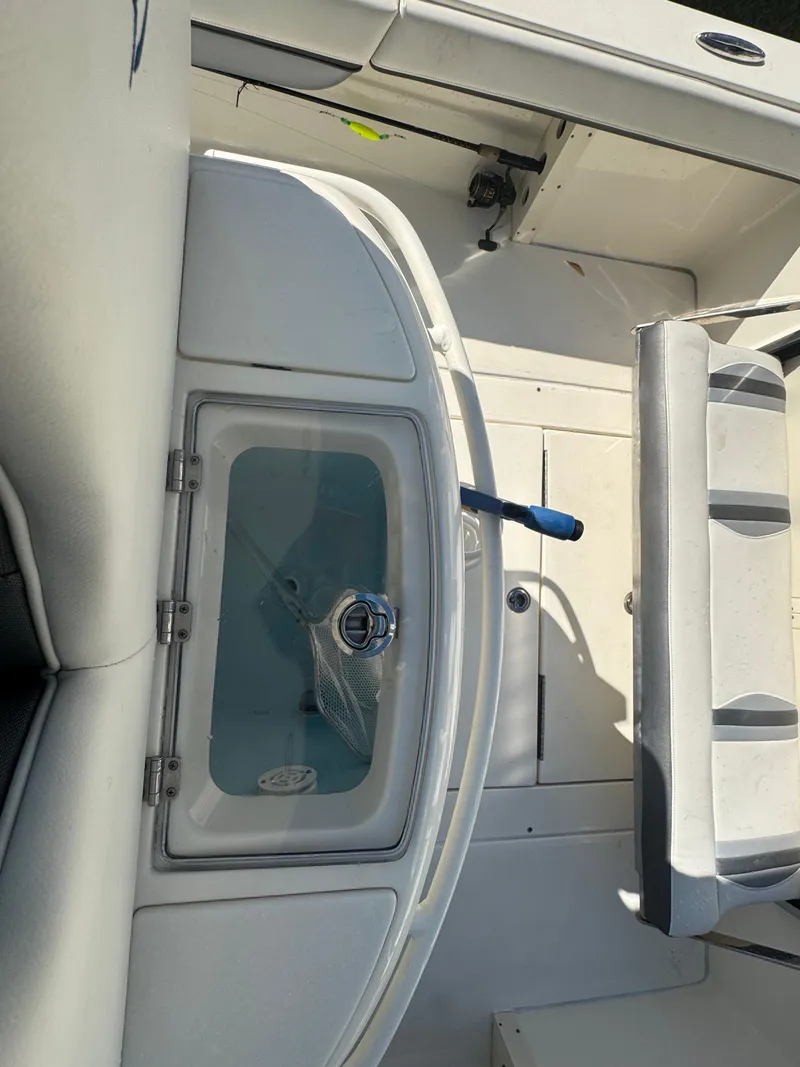 Slide: The Image of 2021 ShearWater 27 Carolina boat interior with seating and storage compartments. - 38