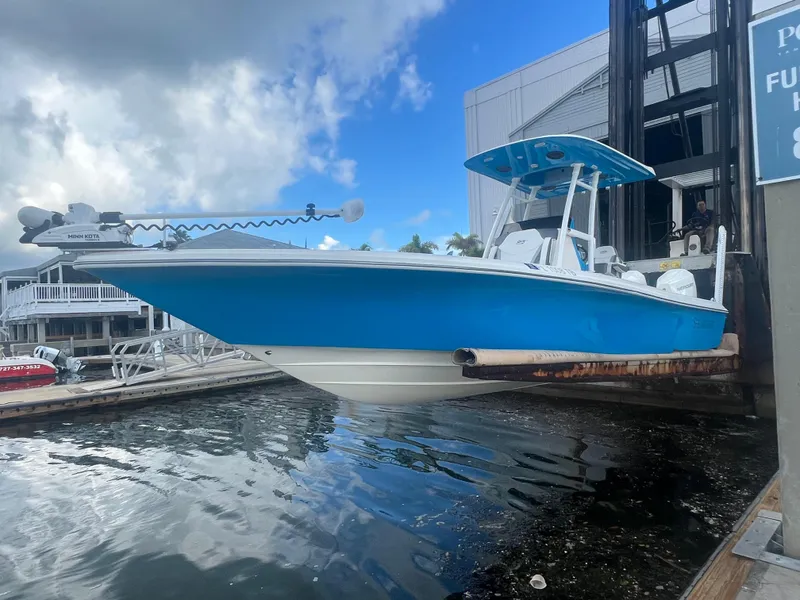 Slide: The Image of 2021 ShearWater 27 Carolina boat in vibrant blue, docked at a marina. - 4