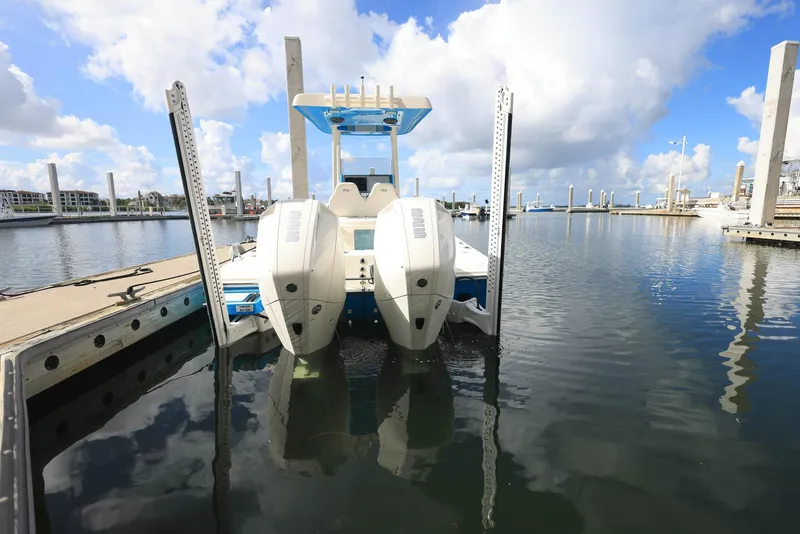 Slide: The Image of 2021 ShearWater 27 Carolina boat docked in a marina under a cloudy sky. - 5
