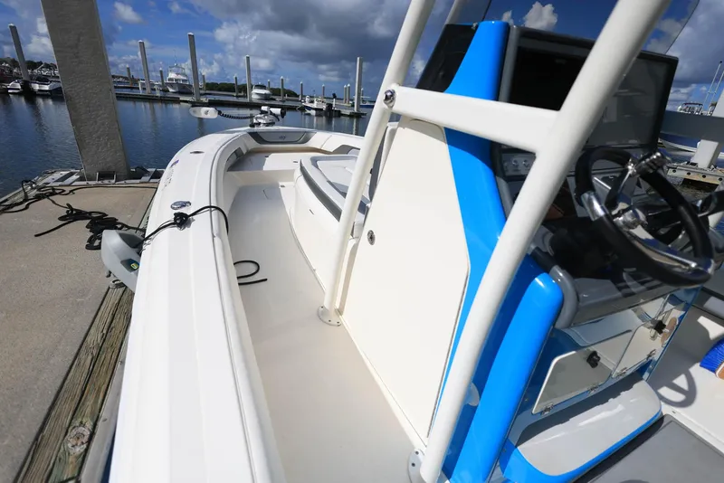 Slide: The Image of 2021 ShearWater 27 Carolina boat docked at marina under cloudy sky. - 6