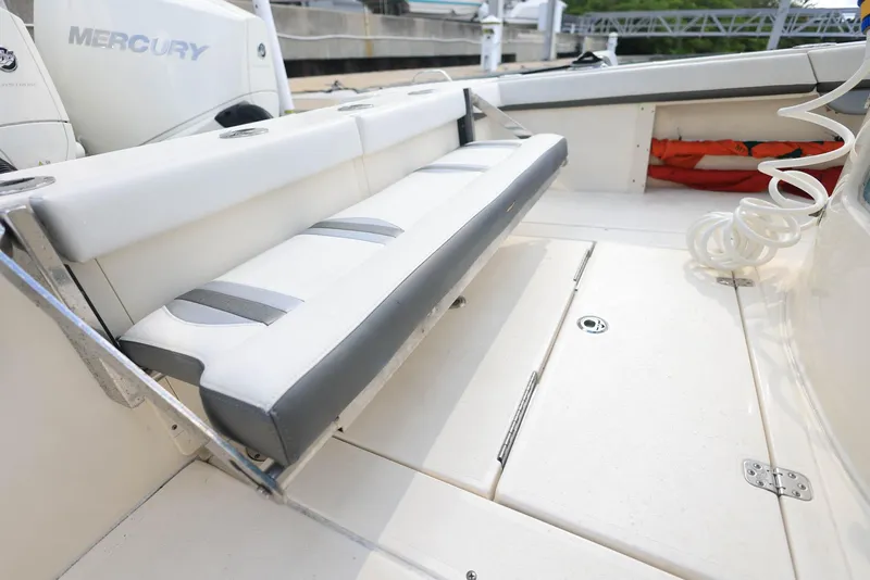 Slide: The Image of 2021 ShearWater 27 Carolina boat interior with foldable seating and Mercury engine. - 8