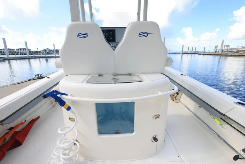 Slide: The Image of 2021 ShearWater 27 Carolina boat interior with dual seats and water view. - 9