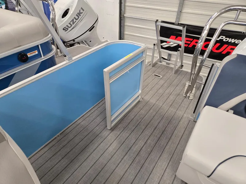 Slide: The Image of 2025 Godfrey Sweetwater 2086 C boat interior with Suzuki engine, gray flooring, and blue panel. - 13