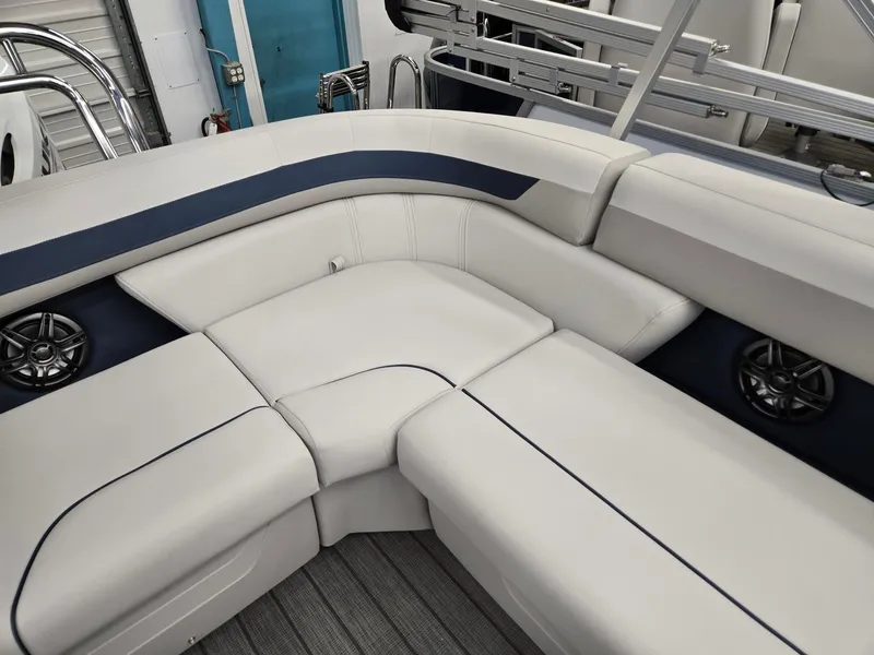 Slide: The Image of 2025 Godfrey Sweetwater 2086 C boat interior with white cushioned seating and built-in speakers. - 15