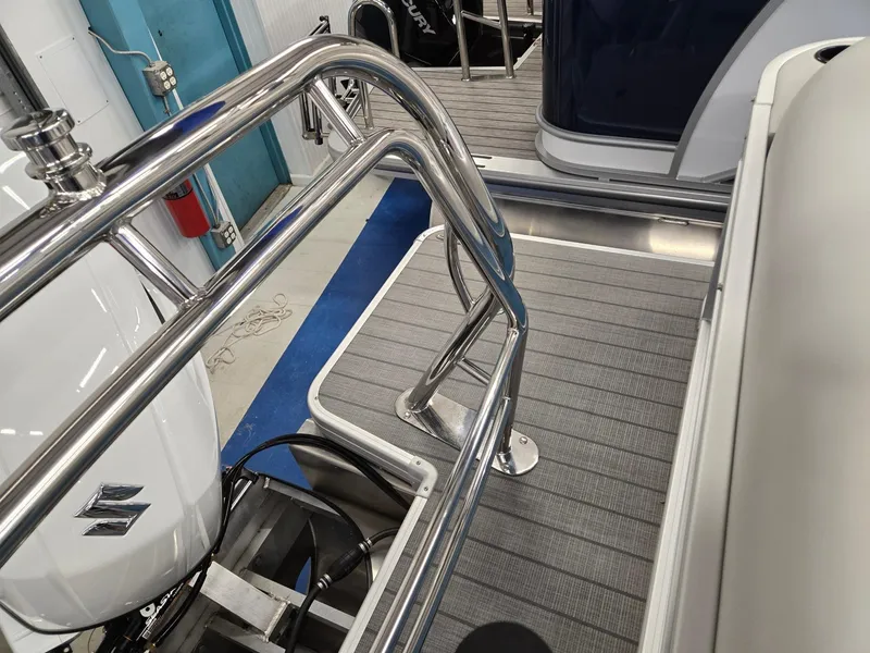 Slide: The Image of 2025 Godfrey Sweetwater 2086 C boat deck with stainless steel railings and Suzuki outboard motor. - 17