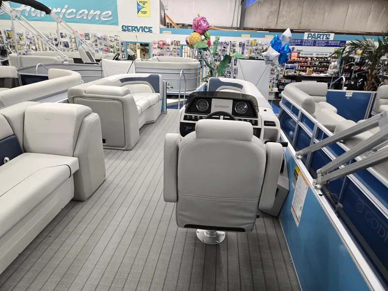 Slide: The Image of 2025 Godfrey Sweetwater 2086 C pontoon boat interior with plush seating and modern dashboard. - 19