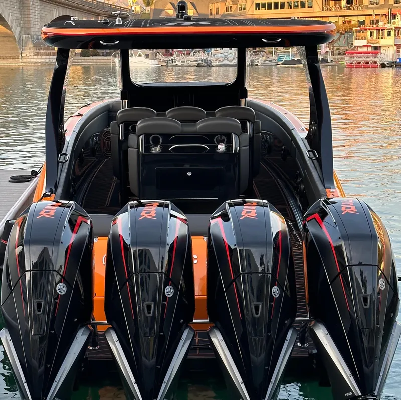 Slide: The Image of 2023 Mystic Powerboats M3800 with four powerful engines docked by the water. - 2