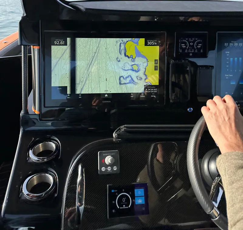 Slide: The Image of 2023 Mystic Powerboats M3800 dashboard with navigation screens and steering wheel. - 6