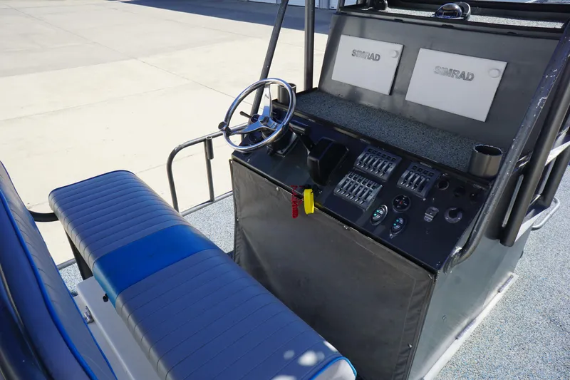 Slide: The Image of 2016 Boat Right 25'8'' Custom Flat cockpit with steering wheel and control panel. - 13